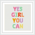 The image features a framed cross stitch pattern with the phrase 'Yes Girl You Can' in bold, colorful letters on a white background.