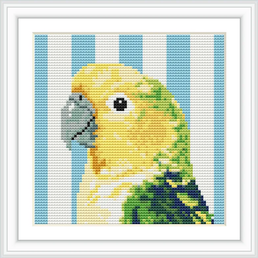 The image features a detailed cross stitch pattern of a yellow and green parakeet with a gray beak, set against a striped blue and white background.