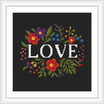 The image depicts the word 'LOVE' surrounded by an array of colorful flowers and leaves, set against a dark background.