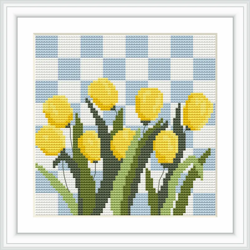 The image depicts vibrant yellow tulips with green leaves, arranged in a neat cluster. They are set against a blue and white checkered background, resembling a picnic blanket or a gingham pattern.