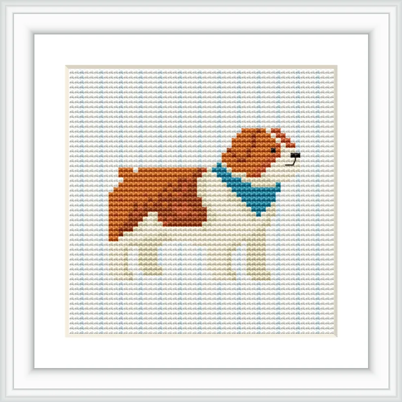 The image features a cross-stitched bulldog wearing a blue bandana, centered in a grid pattern on a white background, framed neatly.