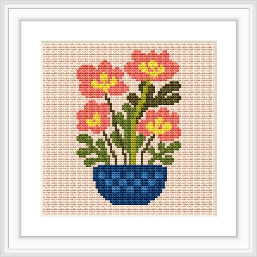The image depicts a cross stitch pattern of a blue vase containing pink flowers with yellow centers and green leaves. It is centered in the frame with a simple background.