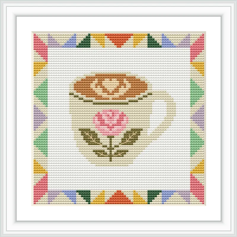 A coffee cup with a rose design and frothy heart is at the center, surrounded by a colorful triangular patterned border.