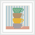 The image features three teacups stacked one on top of the other. The top cup is green with white flowers, the middle cup is beige with a checkered pattern, and the bottom cup is yellow with blue stripes, all set against a background of vertical blue and white stripes.