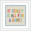 This image features a cross stitch design with the phrase 'IT REALLY IS ALL FUN & GAMES' centered. The text is multicolored with each word in a different color, surrounded by a blue scalloped border.