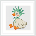 A goose with a cream-colored body is sitting upright, adorned with an orange beak and feet. It wears a green liberty hat with a matching bow under its neck. The background is plain white.