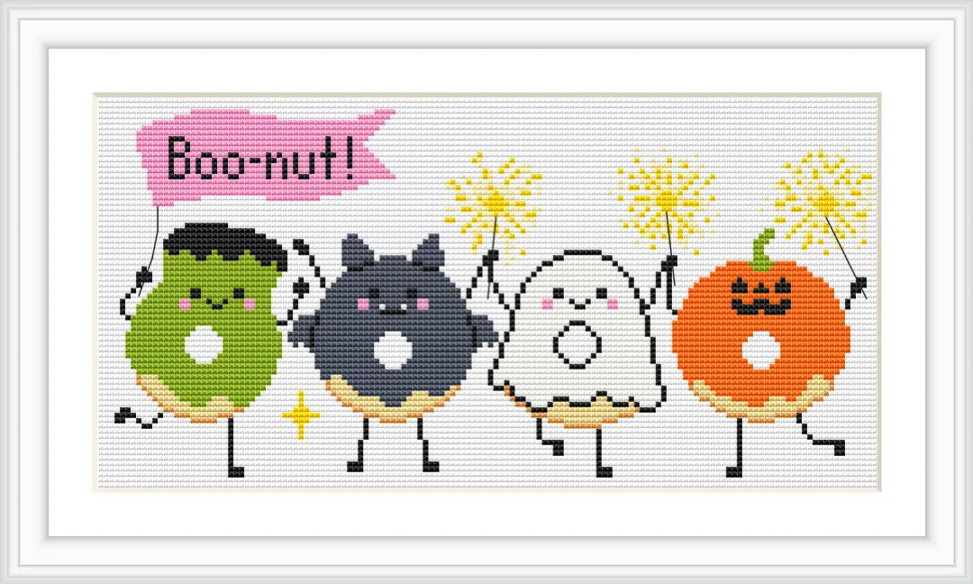 Four cartoon-style donuts, each with a different Halloween-themed character: a green Frankenstein, a black cat, a white ghost, and an orange pumpkin, each holding sparklers. The word 'Boo-nut!' is written above them in a pink speech bubble.