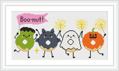 Four cartoon-style donuts, each with a different Halloween-themed character: a green Frankenstein, a black cat, a white ghost, and an orange pumpkin, each holding sparklers. The word 'Boo-nut!' is written above them in a pink speech bubble.