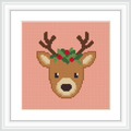 The image depicts a reindeer head on a peach background. The reindeer has antlers and is decorated with red berries and green leaves.