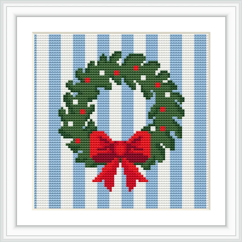 The image features a green wreath with red berries and a large red bow, set against a background of vertical blue and white stripes. The wreath is centered in the frame.