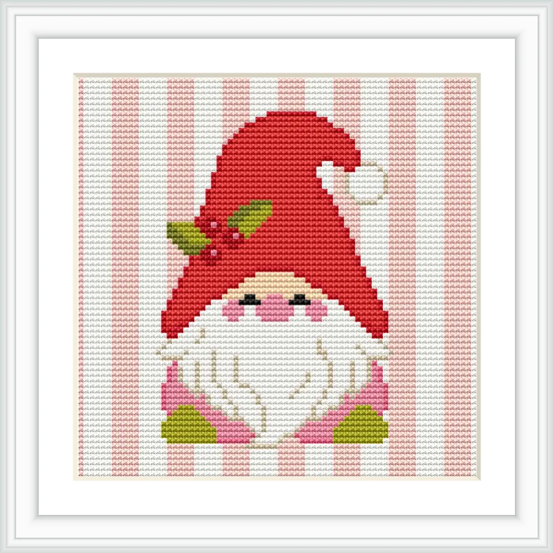 The image showcases a gnome with a red hat, adorned with leaves and berries, standing against a pink and white striped background. The gnome has a long white beard and rosy cheeks.