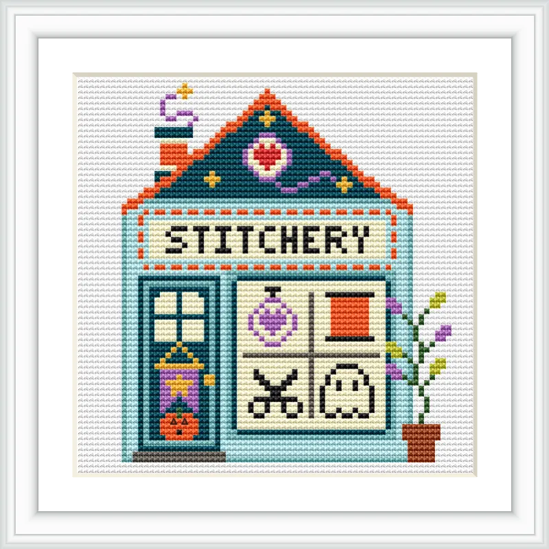This image features a craft shop with the word 'STITCHERY' at the top. The shop has a teal roof, a door with a hanging sign, four window panels, and a potted plant on the side.