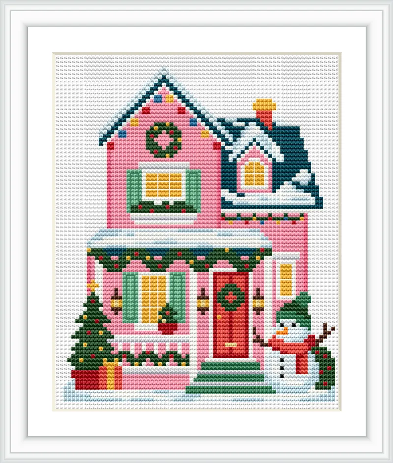 The image depicts a pink Christmas house adorned with green shutters, wreaths, and a snow-covered roof. A snowman stands cheerfully beside the house, and a Christmas tree is decorated next to the entrance.