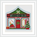 The image depicts a small salon storefront with a sign reading 'Mrs Claus Salon'. It features a green and red color scheme. On the left window, a Santa hat and gift are visible, while the right window shows a comb and mirror. A Christmas tree and present flank the entrance.