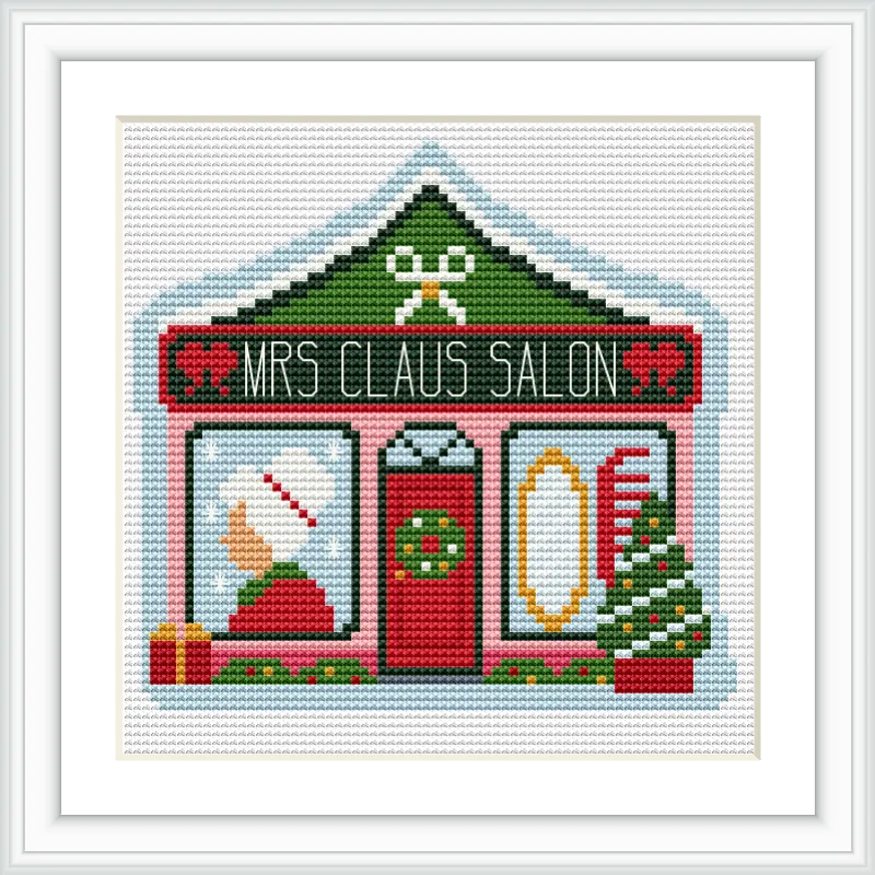The image depicts a small salon storefront with a sign reading 'Mrs Claus Salon'. It features a green and red color scheme. On the left window, a Santa hat and gift are visible, while the right window shows a comb and mirror. A Christmas tree and present flank the entrance.