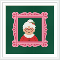 The cross stitch design features a portrait of an elderly woman with white hair in a bun, wearing red clothing and glasses. She is set against a deep green background within a decorative pink frame.