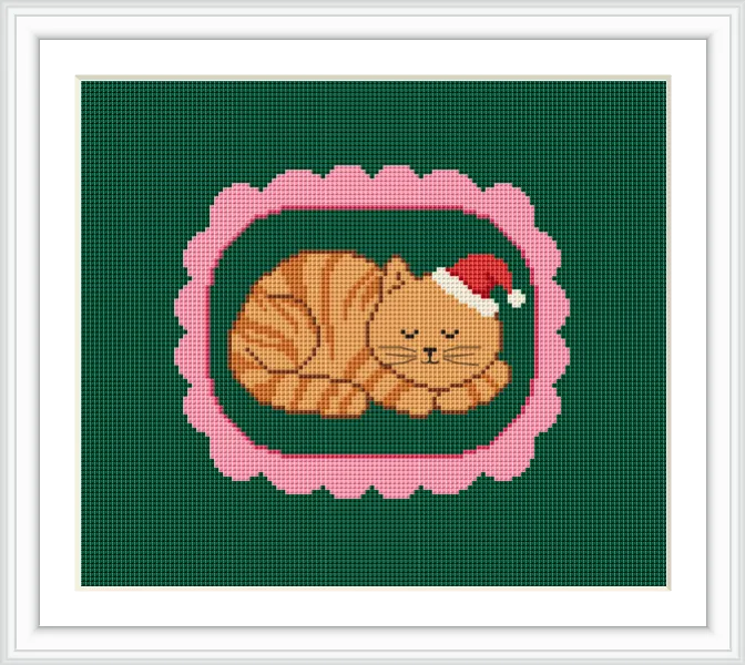 The image depicts a cute, orange-striped cat wearing a Santa hat, peacefully sleeping within a pink, scalloped oval frame against a green background.