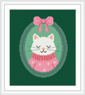 The image shows a white cat wearing a pink sweater and bow, framed in an oval against a green background.