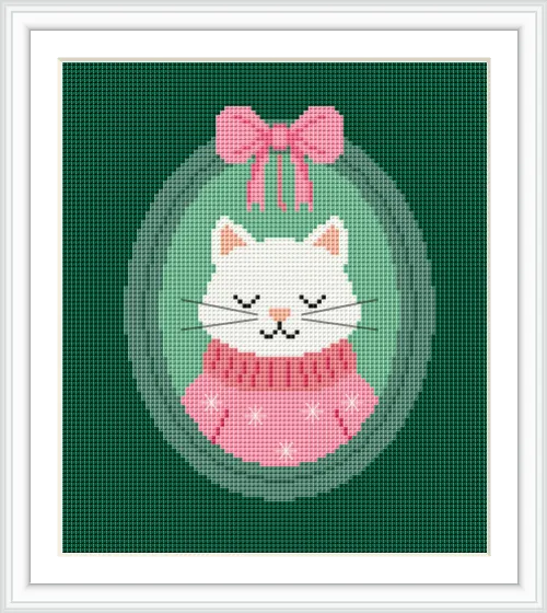 The image shows a white cat wearing a pink sweater and bow, framed in an oval against a green background.