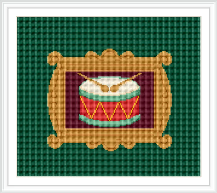 The image shows a decorative frame enclosing a colorful drum with two wooden drumsticks resting on top. The drum features a red and green striped design with yellow accents.