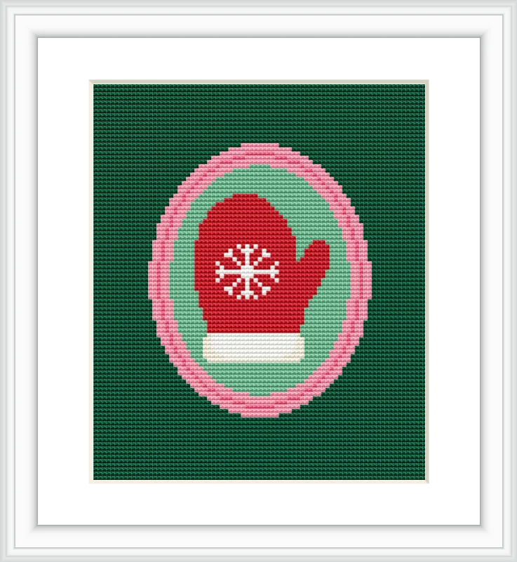 The image shows a single red mitten with a white snowflake design in the center. It is enclosed within circular borders of pink, white, and teal, placed against a dark green background.