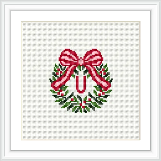 The image shows a decorative wreath made with green leaves and red and white accents, topped with a large red bow, centered around the letter 'U'.