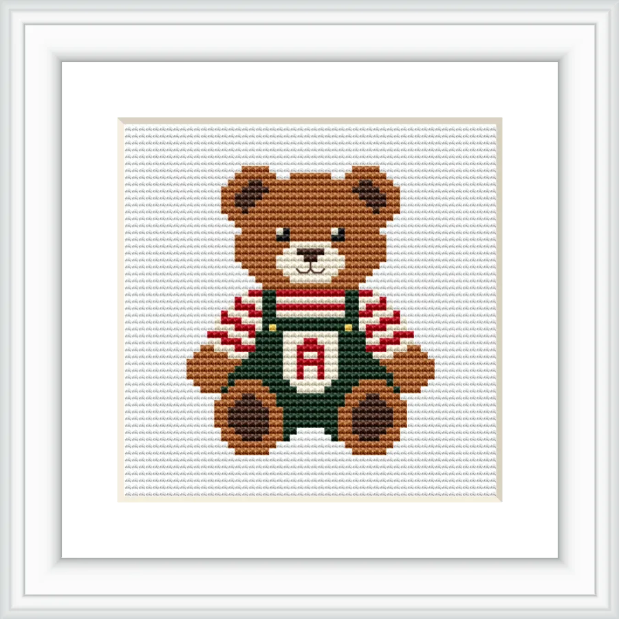The image shows a cute brown bear wearing green overalls and a red and white striped shirt, centered on a white background. The overalls have an 'A' monogram on the chest.
