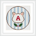 The image features a cross stitch pattern of a cat's head with pointed ears and the letter 'A' in red on the face. The background is composed of vertical blue and white stripes, and there is a small green wreath at the bottom.