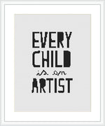 The image displays a cross stitch pattern with the phrase 'EVERY CHILD is an ARTIST' stitched in a bold, sans-serif font. The text is centered on a white Aida cloth framed by a simple, light wood frame.