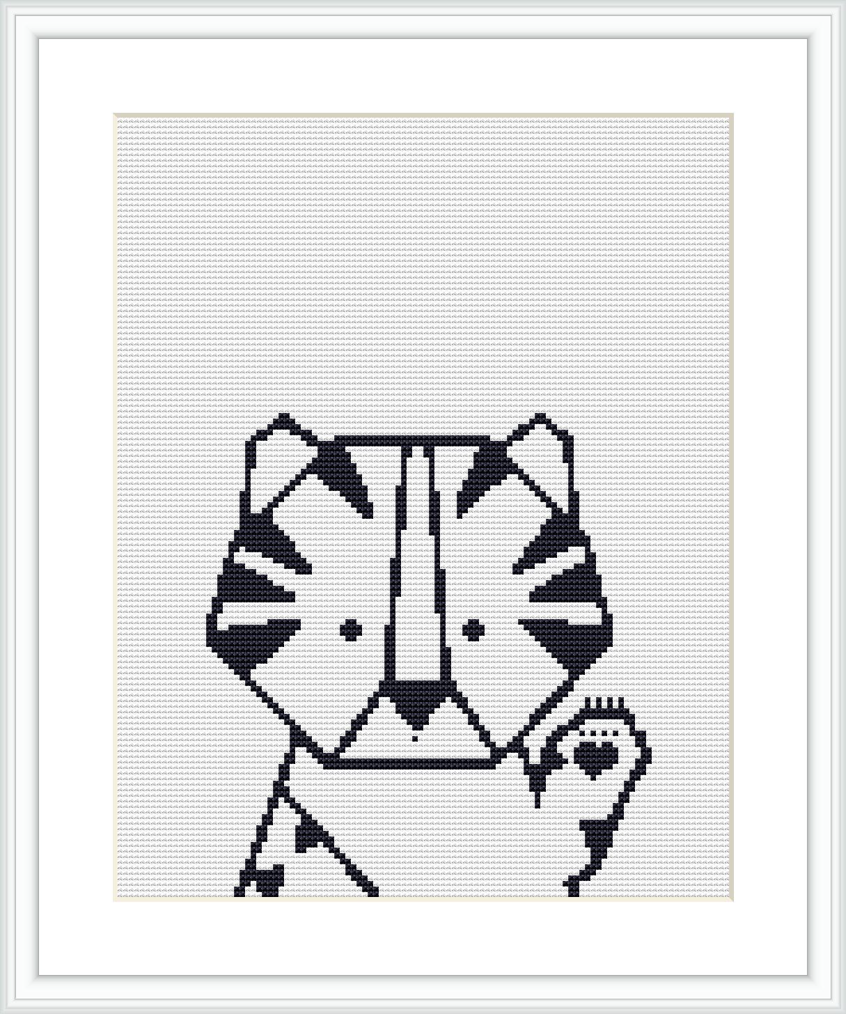 The image shows a framed cross stitch pattern of a stylized tiger head with geometric shapes, centered on a white fabric canvas, surrounded by a light wooden frame.