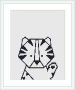 The image shows a framed cross stitch pattern of a stylized tiger head with geometric shapes, centered on a white fabric canvas, surrounded by a light wooden frame.