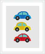 The image displays a cross stitch pattern with three cartoon-style cars stacked vertically. Each car is a different color – the top one is blue, the middle yellow, and the bottom red.