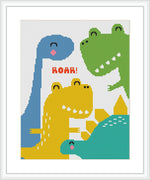 The cross stitch pattern features three stylized dinosaurs in blue, green, and yellow. One is roaring 'ROAR!', while the others show playful expressions. They are set against a white background with a red border.