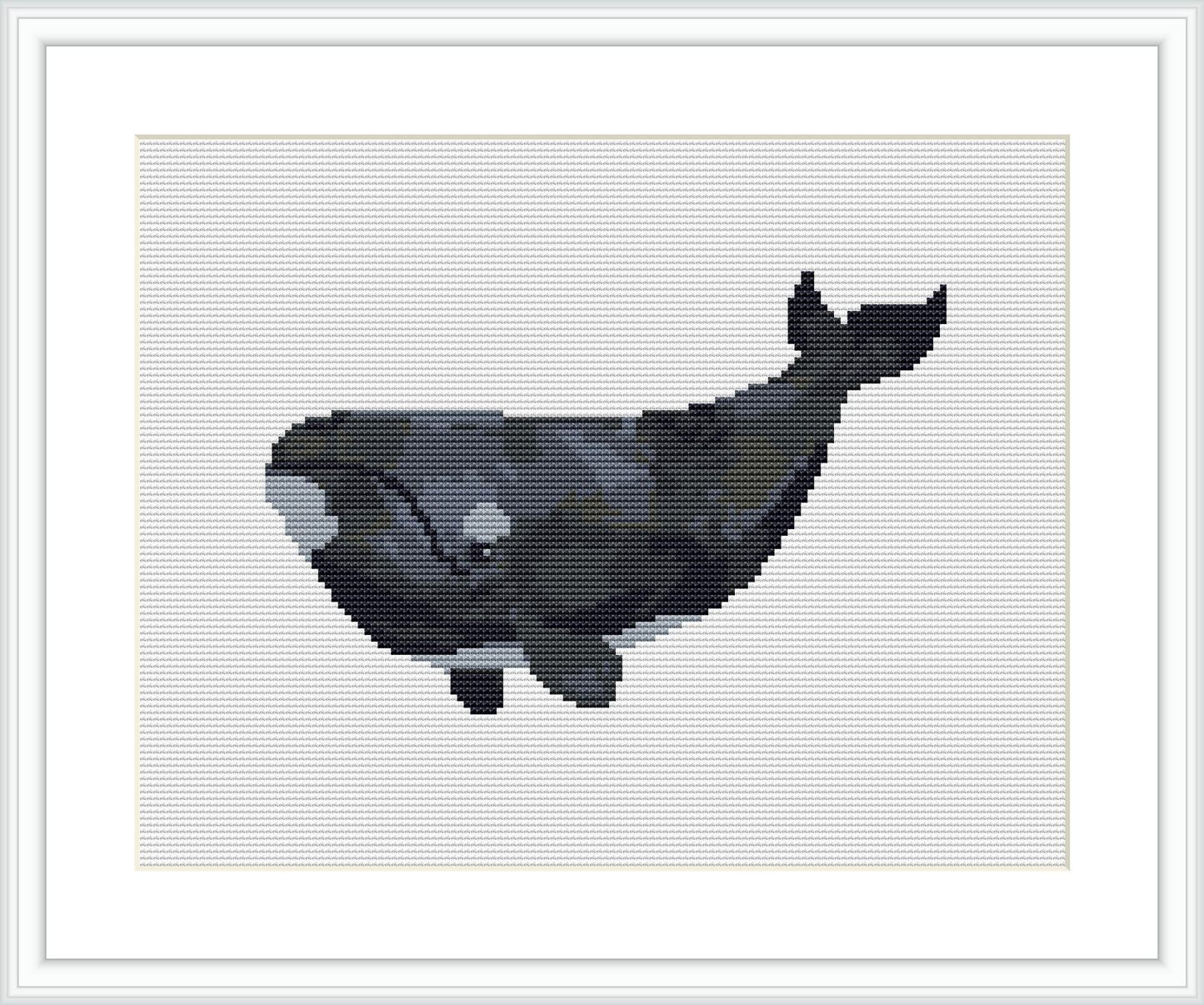 The image displays a cross stitch pattern design of a whale set against a plain, off-white background. The whale is oriented towards the right and appears to be in various shades of grey.