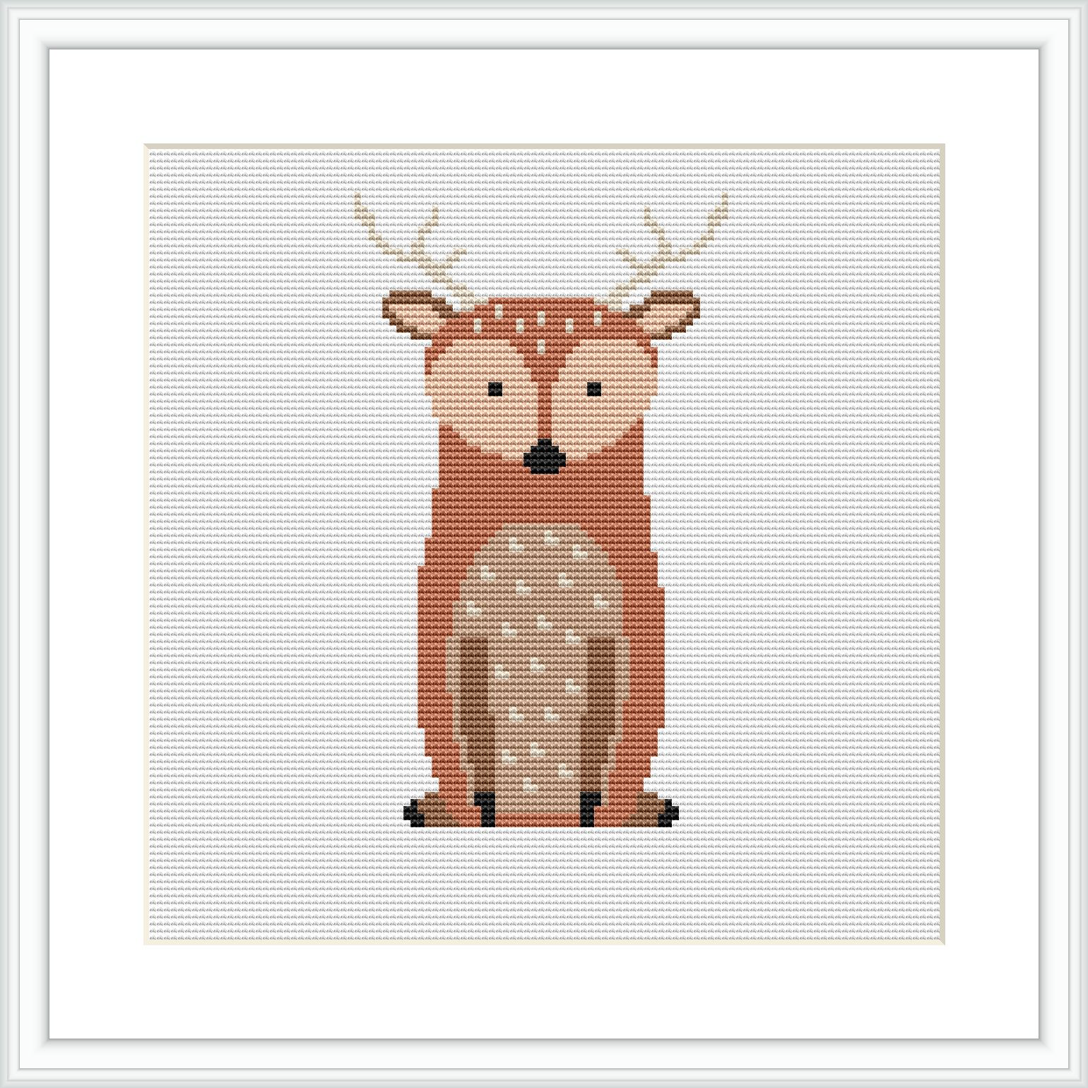 The image shows a cross stitch pattern of a stylized deer centrally placed on a white canvas within a square grid. The deer is depicted with a warm brown and beige color palette and features distinct white spots and black details for the eyes and hooves. The pattern is framed by a simple white border.