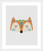 The image depicts a cross stitch design of a stylized fox face with tribal patterns. The design features mirror symmetry, with the fox's eyes closed, centered on a white canvas and framed within a square border.