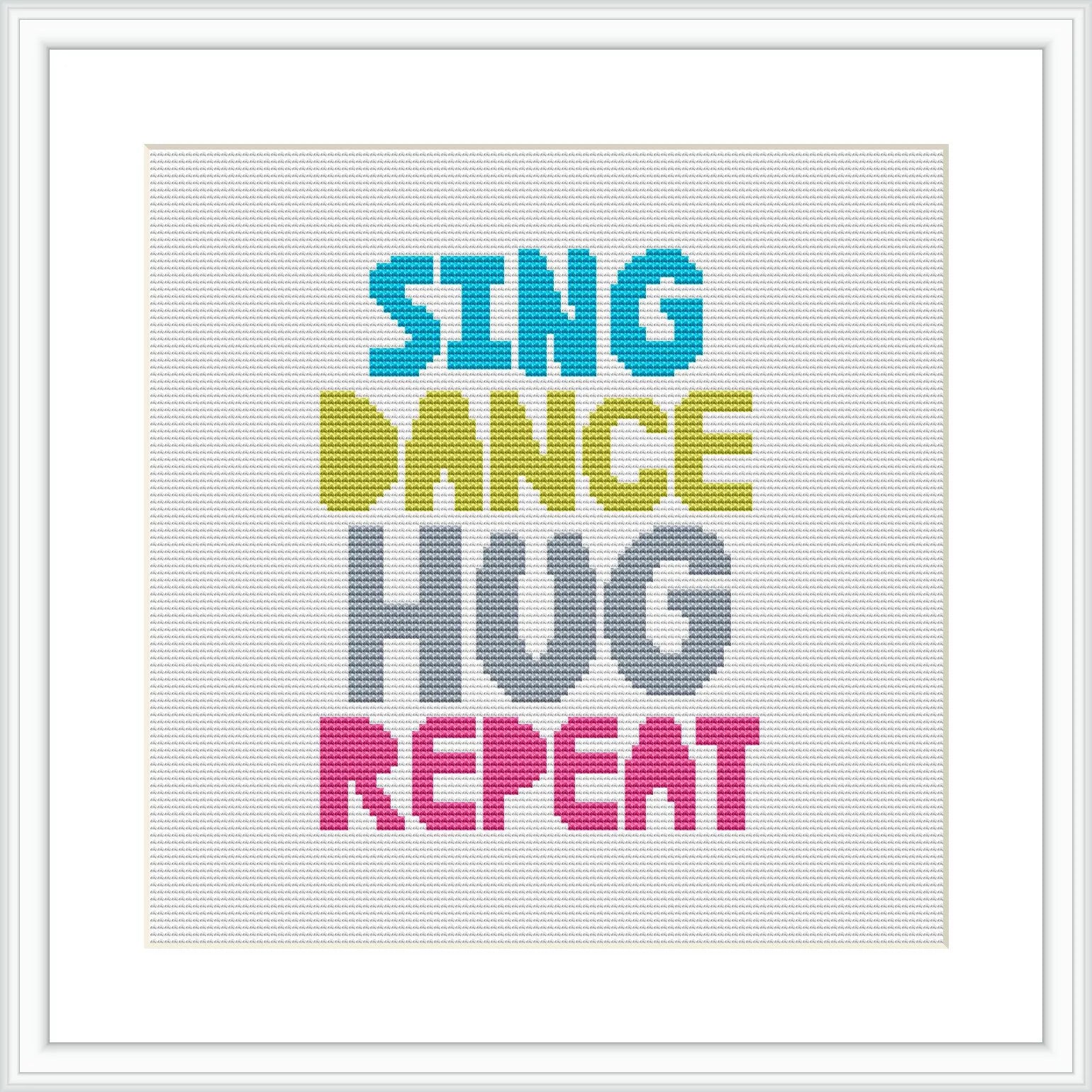 The image shows a framed cross stitch design with the words 'SING DANCE HUG REPEAT' arranged in four lines, each word in a different bold color against a white background.