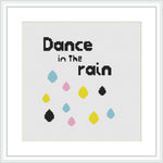 The image displays a cross stitch design featuring the phrase 'Dance in The rain' in a modern, minimalist typography at the top. Below the text, there is a series of colorful raindrops in turquoise, yellow, pink, and black arranged against a white background.