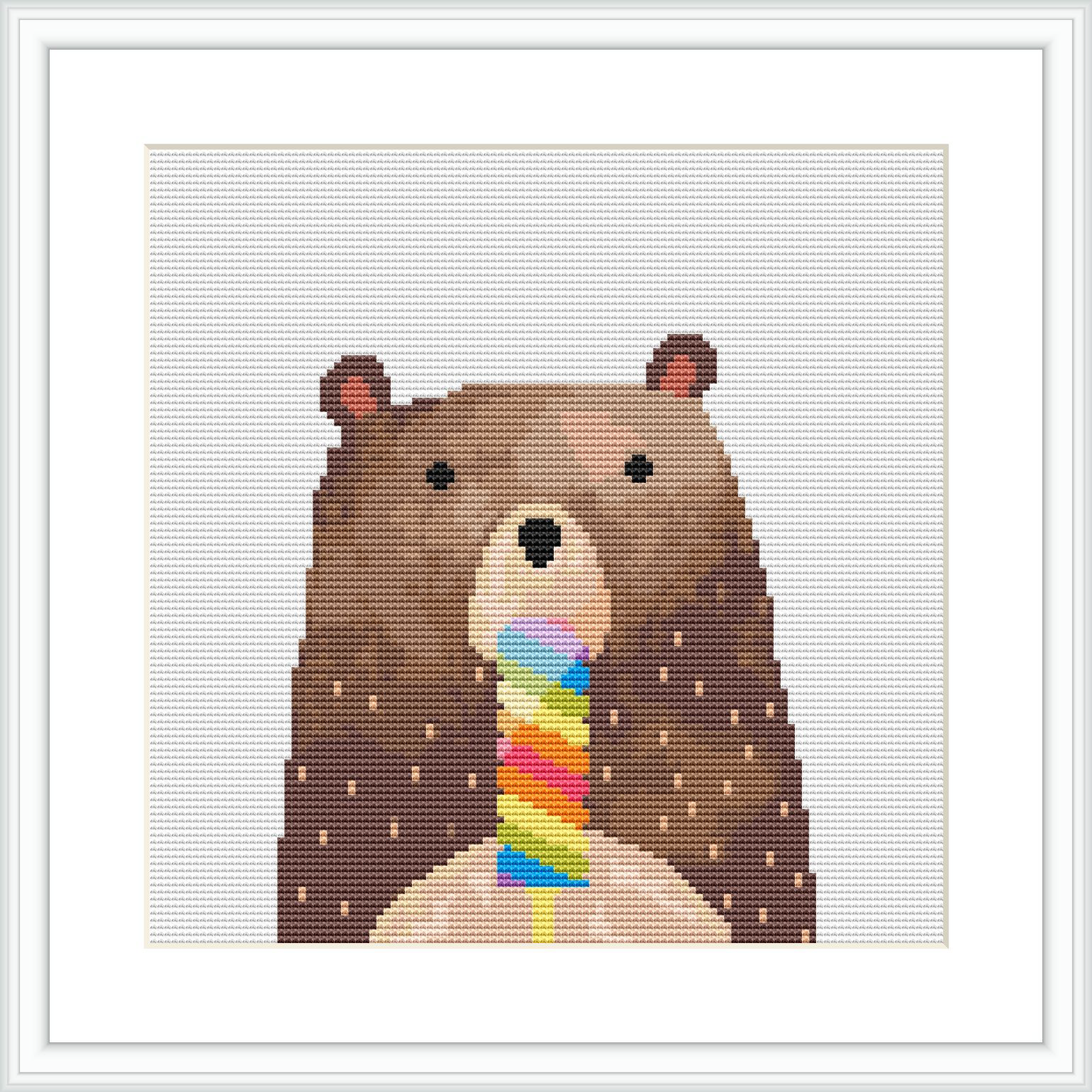 The image depicts a cute brown bear with a simplistic, stylized appearance, holding a multicolored ice cream cone. The bear stands against a polka-dotted background. The cross stitch pattern is square-shaped, displayed in a frame, giving it a finished look suitable for hanging.