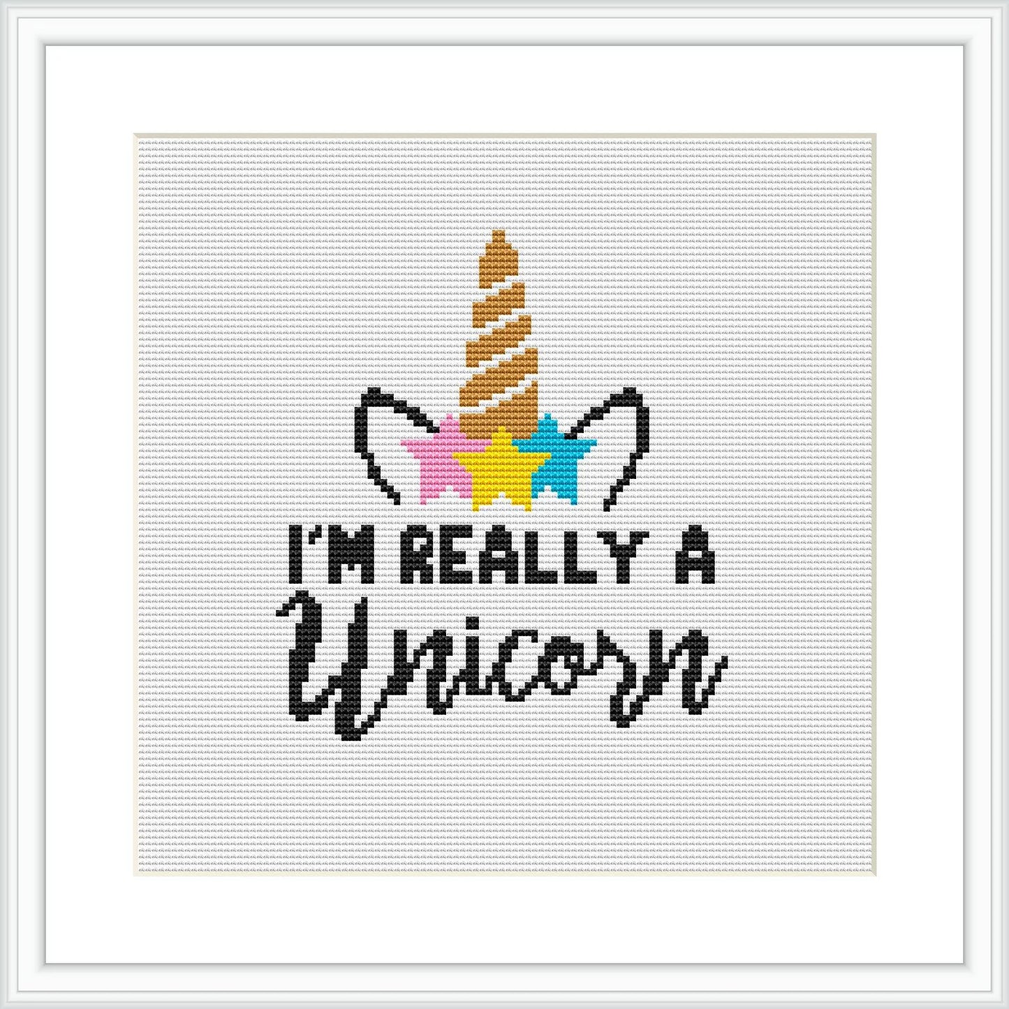 The image is a digital mock-up of a cross-stitch pattern within a square frame. It features a graphic of a unicorn's horn and ears, with colorful stars around, and a cursive typography that states 'I'm really a unicorn'.