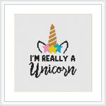 The image is a digital mock-up of a cross-stitch pattern within a square frame. It features a graphic of a unicorn's horn and ears, with colorful stars around, and a cursive typography that states 'I'm really a unicorn'.