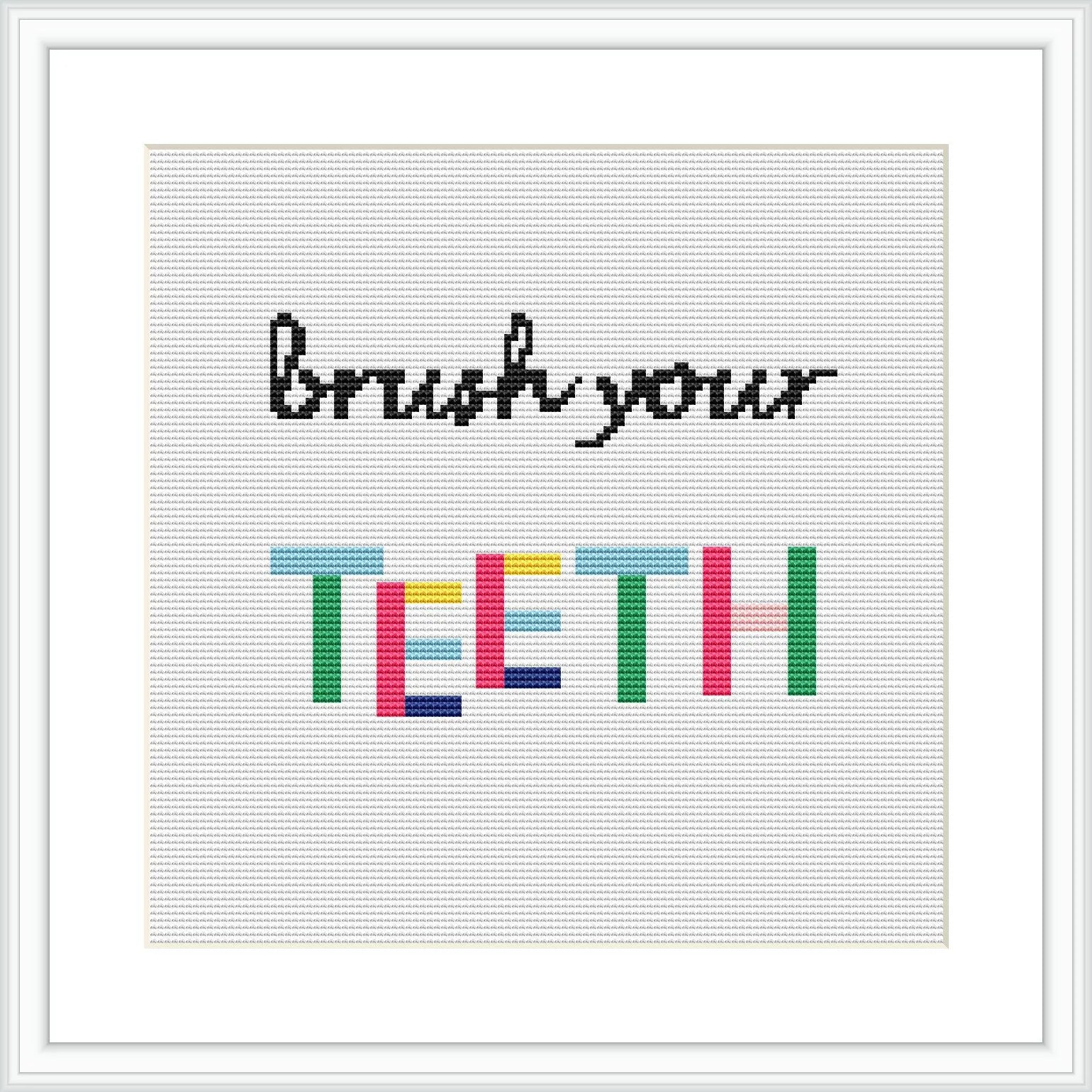 The image shows a framed cross stitch design with the phrase 'Brush your TEETH' where 'TEETH' is written in colorful block letters and 'Brush your' in a simple black font, all on a plain white canvas.