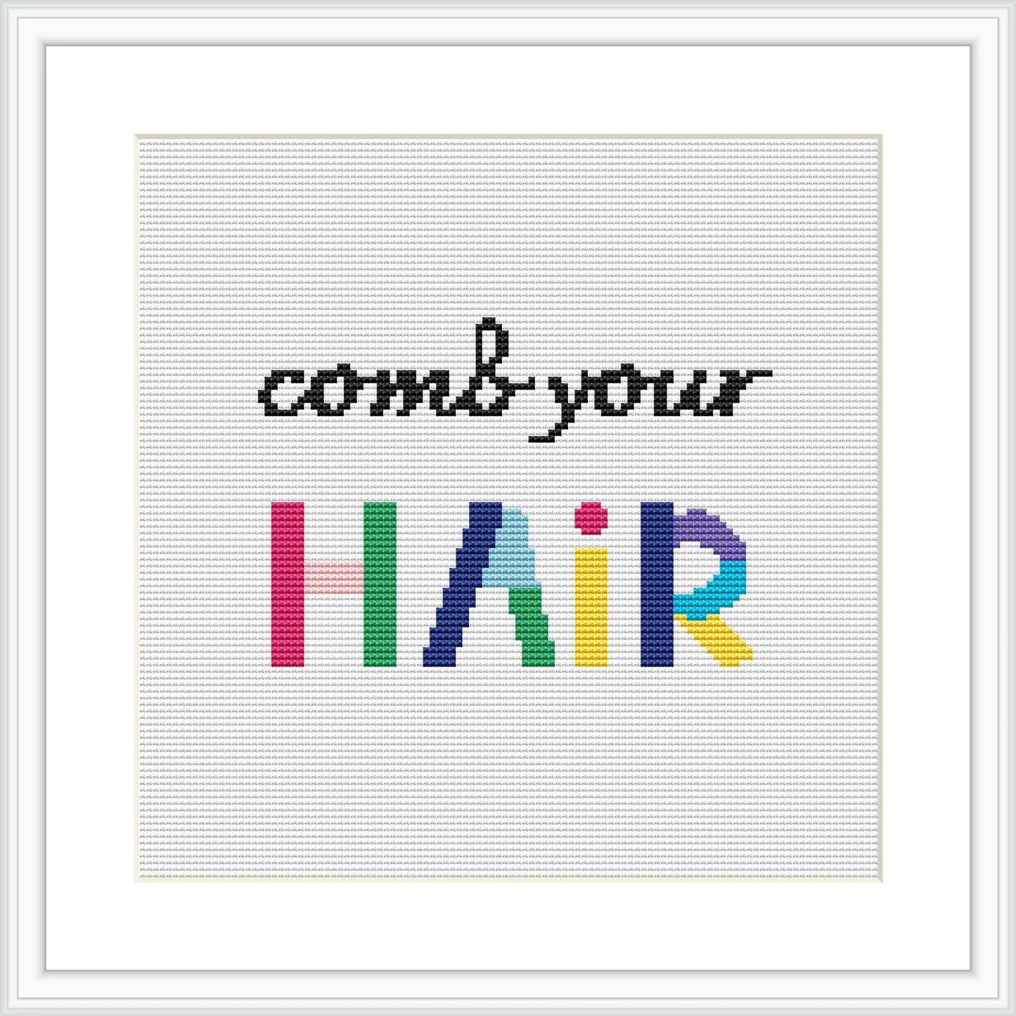 The image depicts a cross stitch pattern with the phrase 'comb your HAIR', where 'HAIR' is written in large, colorful block letters with each character displaying a different color of the rainbow. The rest of the phrase is in smaller black letters. The design is centered on a white aida cloth within a simple, square frame.