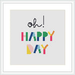 The image shows a framed cross stitch pattern featuring the phrase 'Oh Happy Day' with 'Oh' in cursive black font at the top and 'HAPPY DAY' in colorful block letters below. The pattern is displayed against a white background.