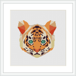 The image is a cross stitch pattern of a tiger's face, centered on a square canvas. The tiger's eyes are strikingly detailed in green, surrounded by fur patterns primarily in orange, black, and white. The pattern is presented within a frame.