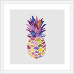 The image displays a framed cross stitch pattern depicting a stylized pineapple with a multicolored mosaic design. The artwork is set against a white background and is placed within a square frame.