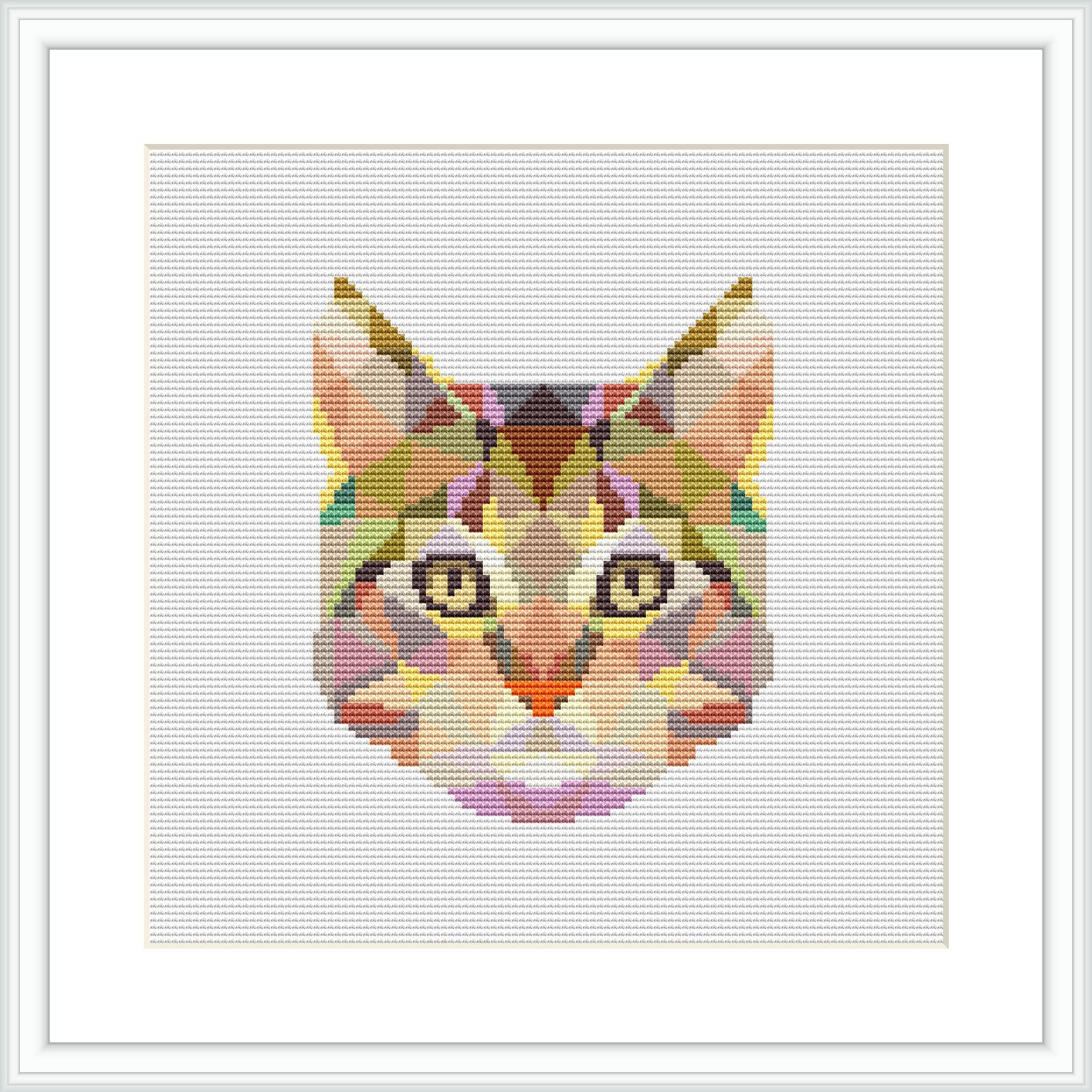 The image displays a framed cross stitch pattern of a cat's face, composed of various geometric shapes and colorful patterns, centered on a white canvas.