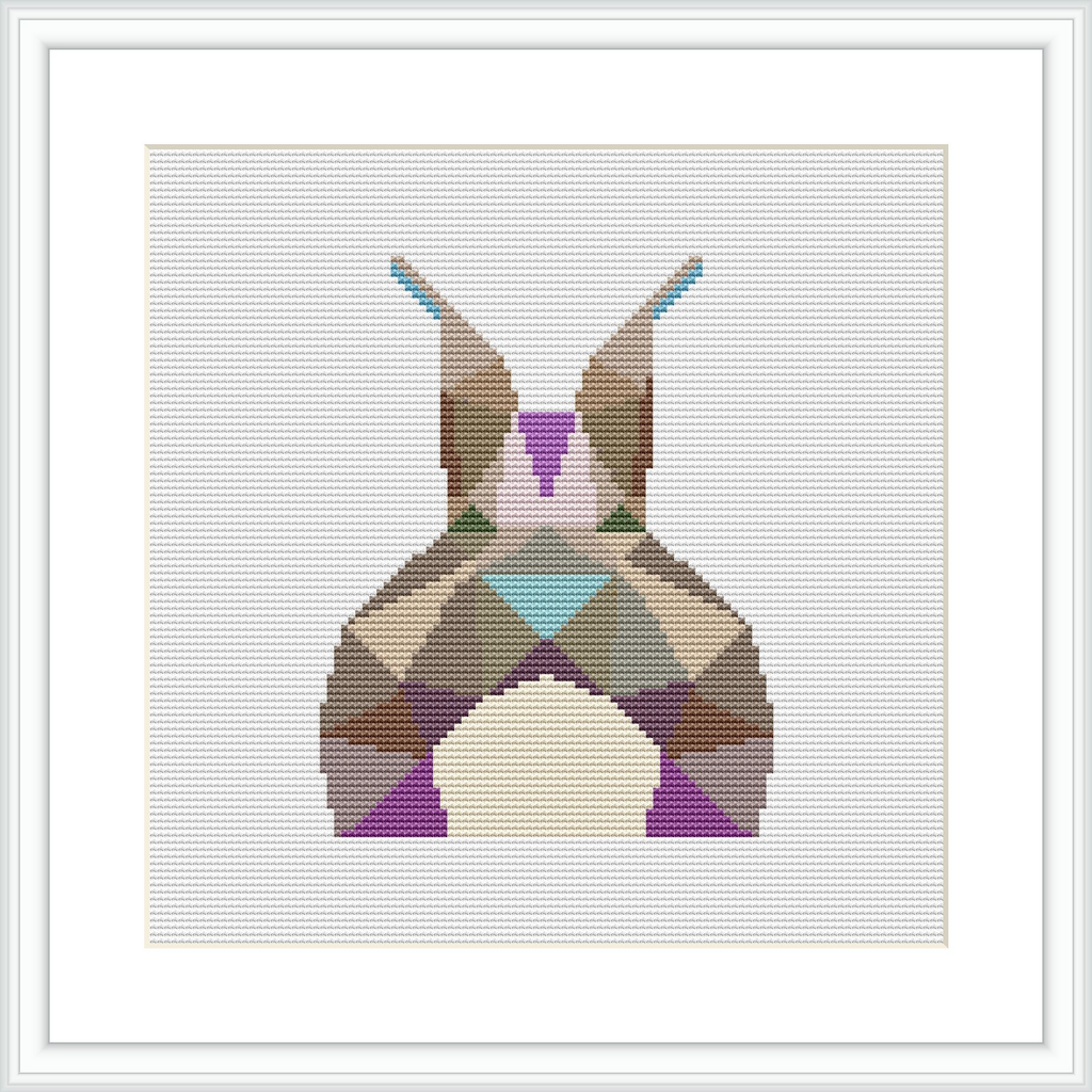 The image showcases a framed cross stitch piece depicting an abstract, geometric representation of a bunny. The bunny is composed of various colorful, pastel geometric shapes set against a white background.