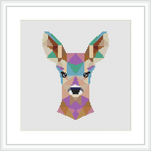 The image features a cross stitch pattern framed in white, depicting a stylized deer head composed of geometric shapes in various colors on a neutral background.