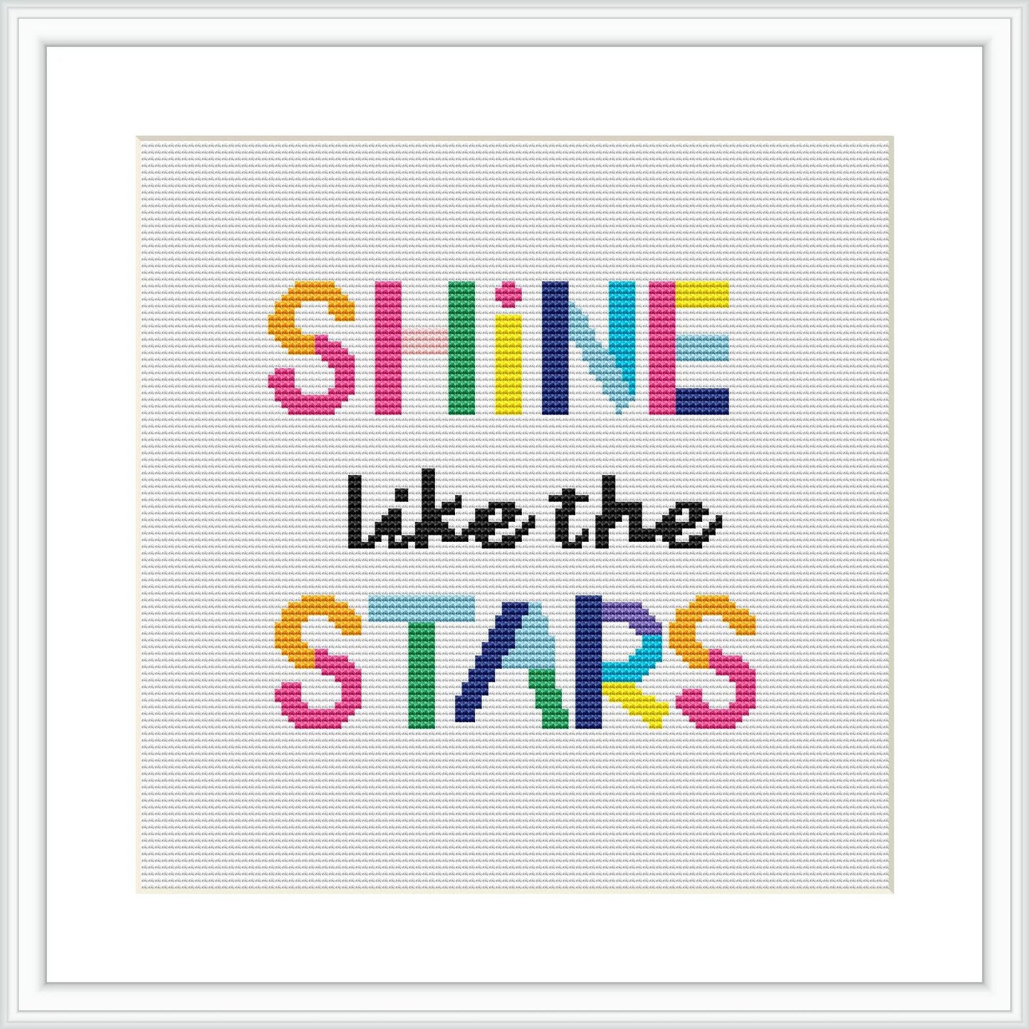 The image displays a framed cross stitch pattern featuring the phrase 'SHINE like the STARS' in block letters. Each row of text has a different color, creating a rainbow-like effect on a white background.